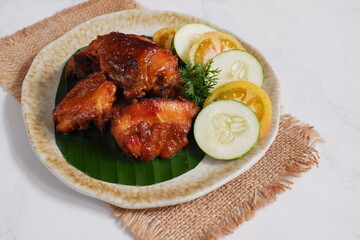 a plate of chicken roasted with vegetables 