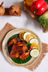 a plate of chicken roasted with vegetables 