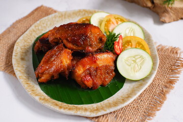 a plate of chicken roasted with vegetables 
