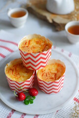 cake topped with cheese grated in a cup against white background 