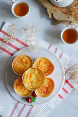 cake topped with cheese grated in a cup against white background 
