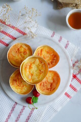 cake topped with cheese grated in a cup against white background 