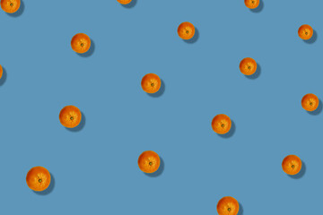 Colorful fruit pattern of fresh tangerines on blue background with shadows. Mandarine. Top view. Flat lay. Pop art design