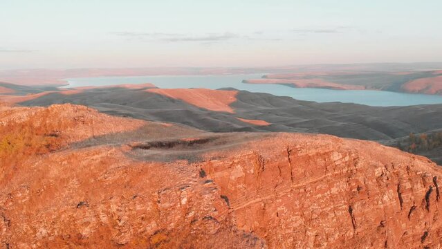 Flight over the top of the cliff in the rays of the evening sun. Tepsey Khakassia. Tepsei evening light and silence. 