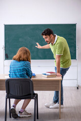 Young teacher and student in the classroom