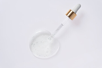 Liquid serum and dropper on a white background.