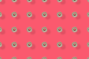 Colorful pattern of rolls of a white toilet paper isolated on pink background. Top view. Wallpaper for bathroom