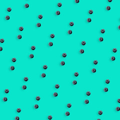 Colorful fruit pattern of fresh blueberries on turquoise background. Top view. Flat lay. Pop art design