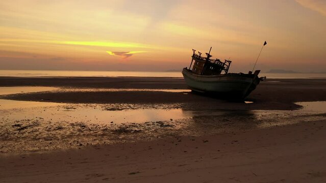 Sunset drone flight scene of boat wreck along shore side - Nathon harbour - Koh Samu Island in Thailand