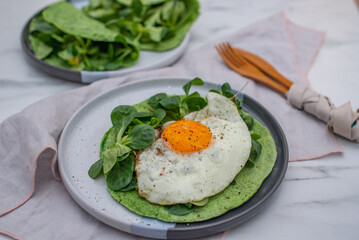 Delicious spinach crepes green colored pancake with vegetables