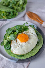 Delicious spinach crepes green colored pancake with vegetables