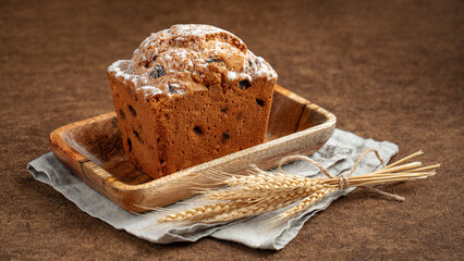 Fresh baked russian stolichny cake with raisins on brown background