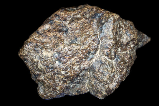 Chondrite Meteorite stone isolated on black background. Piece of rock formed during the Solar System creation.