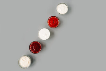 Various sauces in row, copy space. Top view.