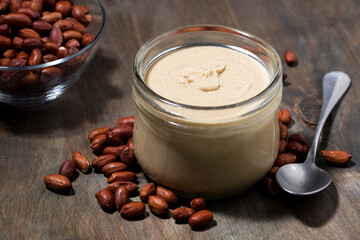 peanut butter in  glass jar on  wooden background