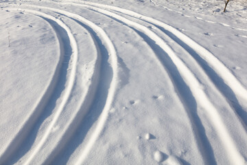 Trail from a car in the snow in winter.