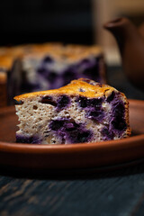 piece of blueberry pie on a clay plate, vertical closeup
