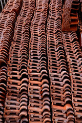Stack of Red roof tiles for a Buddhist Temple restoration at Thailand.