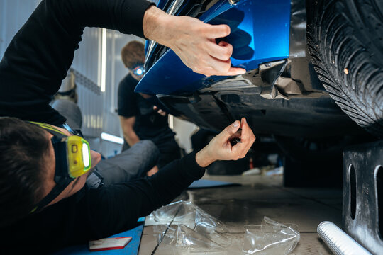 Car detailing. Man applies nano protective coating to the car in car detailing service