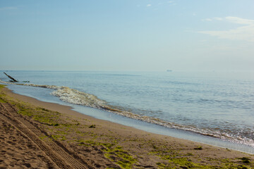 Beautiful sea at noon in summer, clear water, sand beach. silent waves are illuminated by the midday sun. seascape in Ukraine.