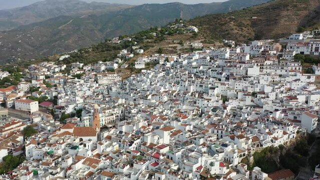 Aerial view of central areas of Competa overlooking parish Church of Assumption on sunny fall day, Andalusia, Spain. High quality 4k footage