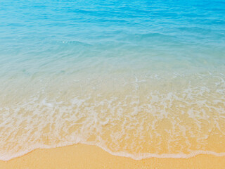 Fototapeta na wymiar Waves of the sea on the sandy beach. summer vacation beach background