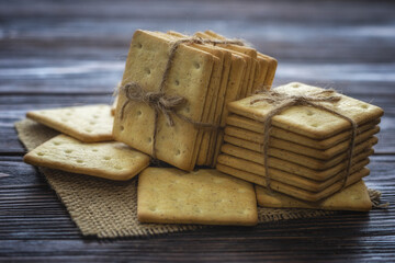 A stack of crackers tied with string on sackcloth. 