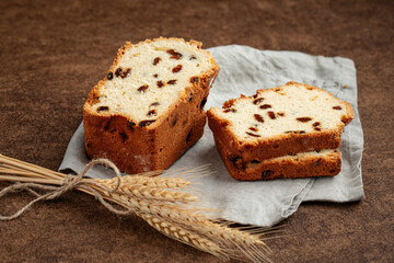 Russian sliced stolichny cake with raisins on brown background