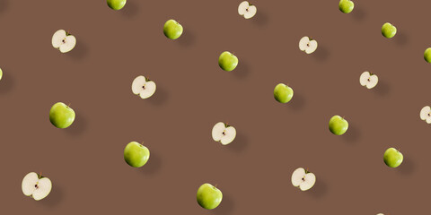 Colorful fruit pattern of fresh green apples on brown background with shadow. Top view. Flat lay. Pop art design, creative summer concept