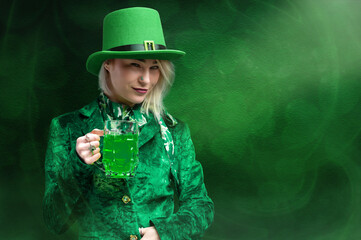 St. Patrick's Day leprechaun model girl holding beer on green magic background with shamrock leaves