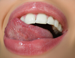 Dental care, healthy teeth and smile, white teeth in mouth. Closeup of smile with white healthy teeth. Open mouth, tongue touches the teeth. © Volodymyr