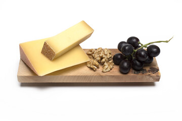 wedge cheese grapes walnuts white background