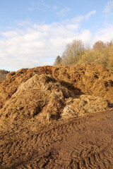 a large dung heap on a horse farm