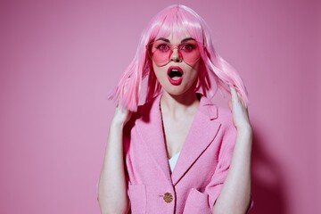 Portrait of a young woman bright makeup pink hair glamor stylish glasses color background unaltered