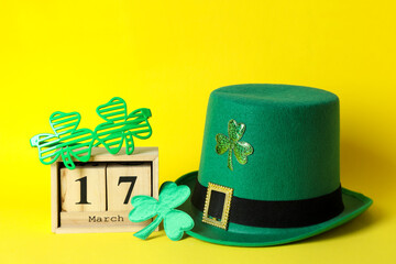 Different St.Patrick's Day accessories on yellow background