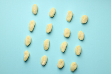 Flat lay with raw potato gnocchi on blue background