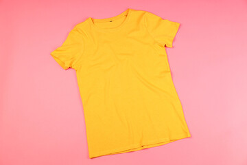 Yellow t-shirt with space for print on pink background