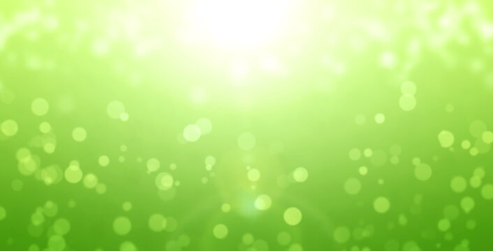 Horizontal sunny background of green color with yellow sparks. Abstract nature background
