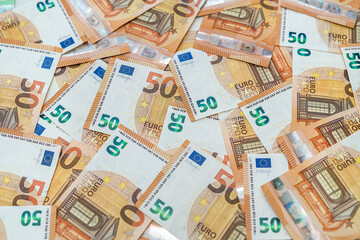 beautiful new clean 50 euro banknotes scattered on a spacious new table.