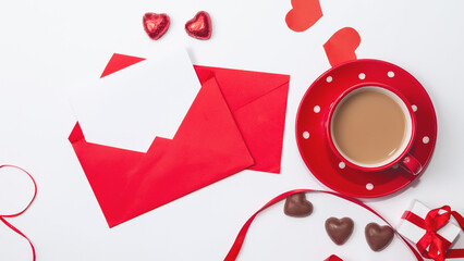 Beautiful Valentines composition of gift, Red envelope with blank white note mockup inside, chocolate heart shaped, coffee in Happy Valentines, Mothers and fathers day and love celebration concept.