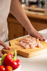 Obraz na płótnie Canvas Cooking dinner with chicken on a kitchen