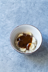 Porridge with Tahini Molasses and Banana for Healthy Organic Breakfast.
