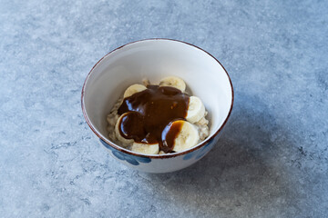 Porridge with Tahini Molasses and Banana for Healthy Organic Breakfast.
