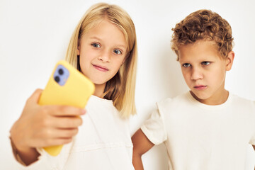 Portrait of his he her playing mobile games on his phone light background