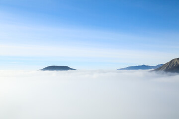 Traveler hiking in mountains clouds landscape