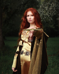 Young red haired woman in medieval dress. Fantasy portrait of a girl. Historical cosplay of noble...