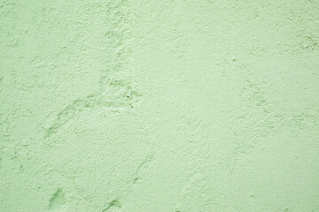 Green textured plastered wall, background, texture wallpaper.
