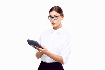 Fototapeta premium Young woman accountant with a calculator in her hands wearing white shirt glasses on a white isolated background. Business woman counting income