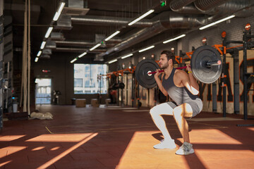 Caucasian man do sit ups with heavy weight barbell