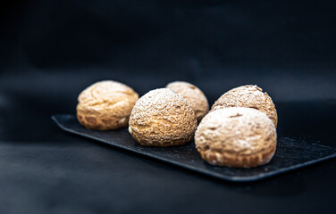 Appetizing Shu cakes on a black background.
